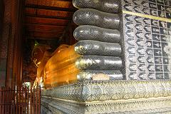 
Also known as the Temple of the Reclining Buddha, Wat Po was built by Rama I in the 16C and is the oldest and largest Buddhist temple in Bangkok. The enormous Reclining Buddha is 46m long and 15m high, with each foot 3m high and 5m long. The statue is brick, covered with layers of plaster, and gold leaf. The most striking part of the statue is its soles, which are decorated with 108 auspicious patterns inlaid with mother-of-pearl.
